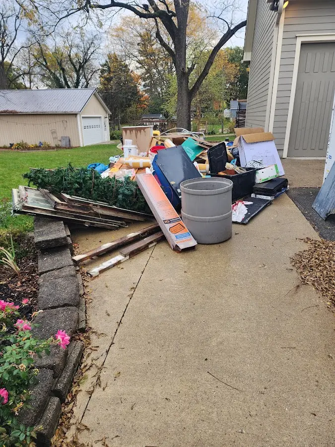 Dumpster being loaded with debris for Estate Cleanout Dumpster Rental in Chesterfield